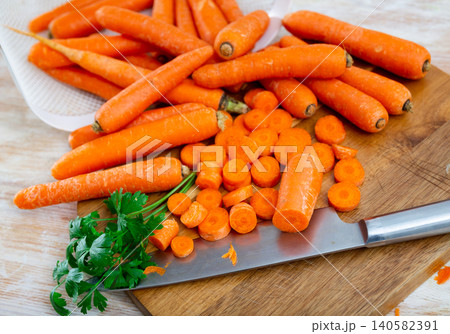 Whole and sliced raw carrot on table 140582391