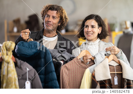 Family shopping, international couple purchase warm clothes in shop Family shopping, international couple purchase warm clothes in shop 140582478