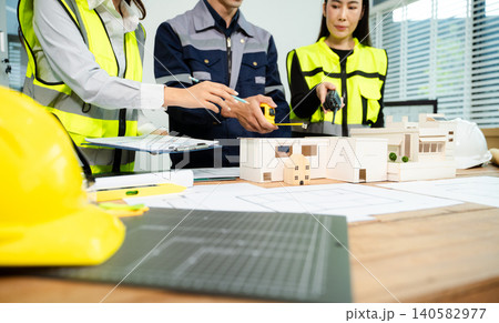 Engineer teams meeting working together wear worker helmets hardhat on construction site Engineer teams meeting working together wear worker helmets hardhat on construction site 140582977
