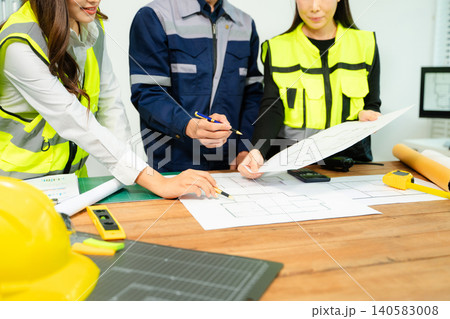 Creative architect projecting on the big drawings with architectural project at construction site at desk Creative architect projecting on the big drawings with architectural project at construction site at desk 140583008