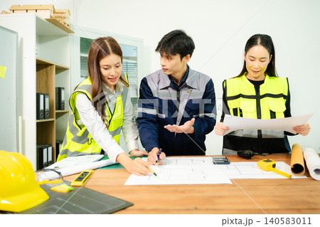 Creative architect projecting on the big drawings with architectural project at construction site at desk Creative architect projecting on the big drawings with architectural project at construction site at desk 140583011