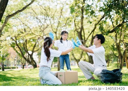 Joyful family volunteering to clean a park together. A heartwarming outdoor scene promoting teamwork, love, and environmental awareness in a green lifestyle. Joyful family volunteering to clean a park together. A heartwarming outdoor scene promoting teamwork, love, and environmental awareness in a green lifestyle. 140583420
