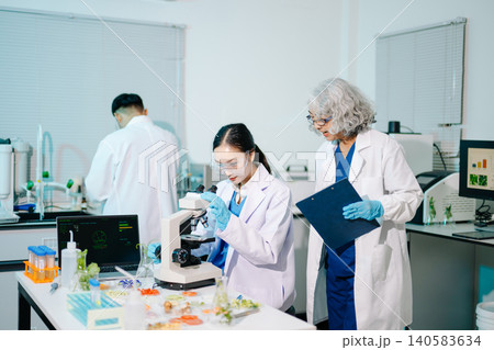 Professional scientists performing laboratory research with microscopes, biotechnology testing, medical innovation and healthcare science in a modern lab. Professional scientists performing laboratory research with microscopes, biotechnology testing, medical innovation and healthcare science in a modern lab. 140583634