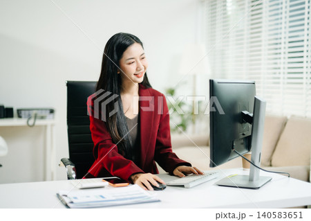 Business woman using tablet and laptop for doing math finance on an office desk, tax, report, accounting, statistics, and analytical research concept in office Business woman using tablet and laptop for doing math finance on an office desk, tax, report, accounting, statistics, and analytical research concept in office 140583651