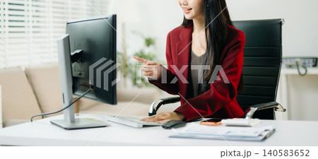 Business woman using tablet and laptop for doing math finance on an office desk, tax, report, accounting, statistics, and analytical research concept in office Business woman using tablet and laptop for doing math finance on an office desk, tax, report, accounting, statistics, and analytical research concept in office 140583652