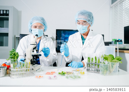 Scientists conducting laboratory biotechnology research, analyzing plant and food samples for GMO testing, nutrition safety, pharmaceutical innovation and clinical development. Scientists conducting laboratory biotechnology research, analyzing plant and food samples for GMO testing, nutrition safety, pharmaceutical innovation and clinical development. 140583911