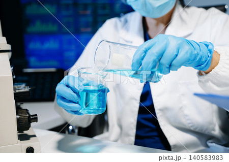 Scientists working together in laboratory analyzing samples and data on digital screen, representing medical research, biotechnology innovation 140583983
