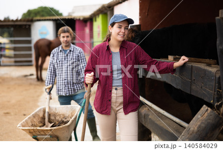 female farm worker standing with a smile and instruments 140584029