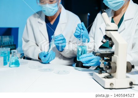 Medical scientists working in laboratory, analyzing test tube samples during research and experiment, reflecting healthcare, science, teamwork Medical scientists working in laboratory, analyzing test tube samples during research and experiment, reflecting healthcare, science, teamwork 140584527