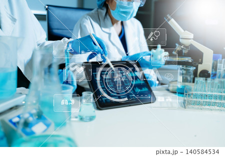 Scientist conducting medical research in modern laboratory using digital healthcare interface, biotechnology analysis, pharmaceutical testing Scientist conducting medical research in modern laboratory using digital healthcare interface, biotechnology analysis, pharmaceutical testing 140584534