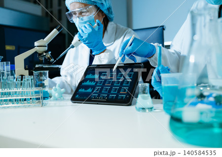 Scientists performing medical laboratory research using DNA analysis, biotechnology technology, microscope testing and digital healthcare data Scientists performing medical laboratory research using DNA analysis, biotechnology technology, microscope testing and digital healthcare data 140584535