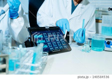 Medical scientists performing biotechnology laboratory research with DNA molecular analysis, microscope testing and digital healthcare technology 140584536