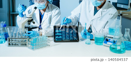 Medical scientists performing biotechnology laboratory research with DNA molecular analysis, microscope testing and digital healthcare technology 140584537
