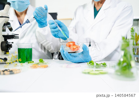 Food scientists in lab coats, testing samples, and analyzing food safety and quality in a modern laboratory 140584567