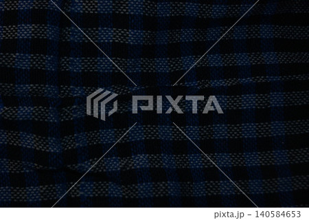 Blue and black checkered fabric texture showing detailed weave with checkered 140584653