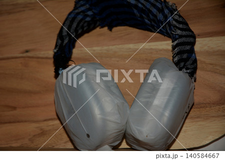 Old pair of grey earmuffs with worn striped headband earmuffs accessory Old pair of grey earmuffs with worn striped headband earmuffs accessory 140584667