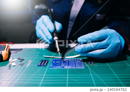 Professional technician soldering PCB circuit board with precision tools in electronics lab, showcasing hardware engineering, manufacturing, repair Professional technician soldering PCB circuit board with precision tools in electronics lab, showcasing hardware engineering, manufacturing, repair 140584782
