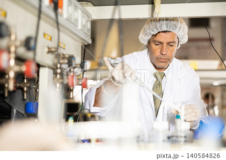 Confident man technician working in research laboratory Confident man technician working in research laboratory 140584826