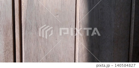 Close-up view of the texture of natural wood planks arranged vertically in light brown to dark brown colors. Close-up view of the texture of natural wood planks arranged vertically in light brown to dark brown colors. 140584827