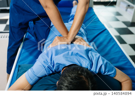 Close up of Physiotherapist working with patient on the bed in clinic Close up of Physiotherapist working with patient on the bed in clinic 140584894