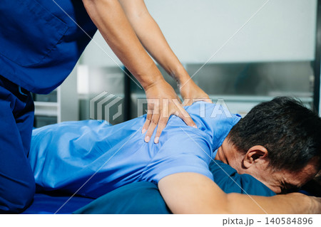 Close up of Physiotherapist working with patient on the bed in clinic Close up of Physiotherapist working with patient on the bed in clinic 140584896