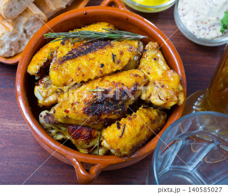 Baked chicken wings in clay pot Baked chicken wings in clay pot 140585027