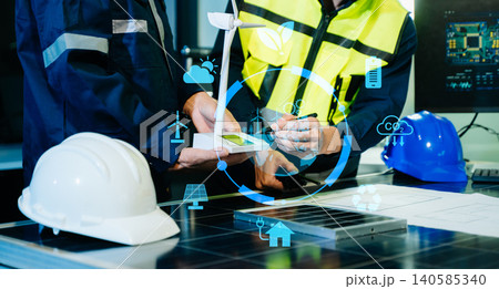 Engineers analyzing solar panels with digital energy data, smart grid technology, renewable power systems, sustainability strategy 140585340