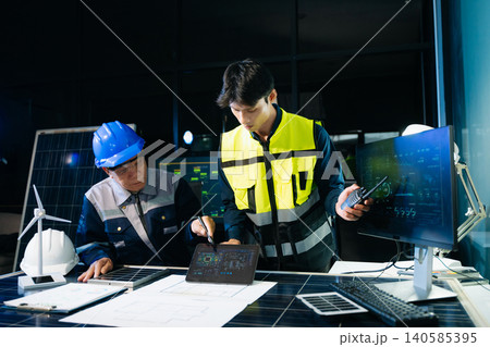 Two business professionals shaking hands over a laptop and tablet, representing a successful partnership, deal closing, and collaboration Two business professionals shaking hands over a laptop and tablet, representing a successful partnership, deal closing, and collaboration 140585395
