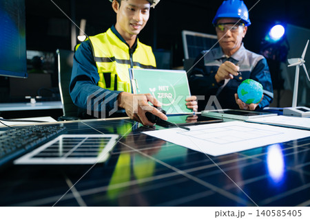 Engineers planning solar energy system for net zero goals. Renewable power, sustainability, green technology Engineers planning solar energy system for net zero goals. Renewable power, sustainability, green technology 140585405