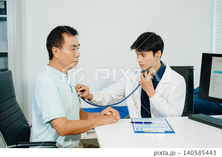 Professional doctor examining patient with stethoscope in modern clinic. Healthcare, diagnosis, medical consultation, trust 140585443