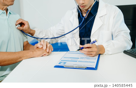 Professional doctor examining patient with stethoscope in modern clinic. Healthcare, diagnosis, medical consultation, trust 140585445