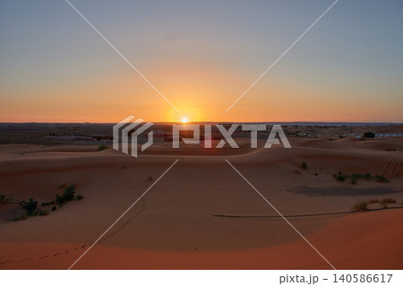 A stunning desert landscape reveals undulating textures in the twilight light of Merzouga, Morocco. A stunning desert landscape reveals undulating textures in the twilight light of Merzouga, Morocco. 140586617
