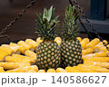 Two pineapples among yellow corn cobs street food stall Two pineapples among yellow corn cobs street food stall 140586627