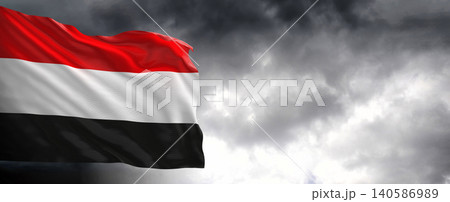 National flag of Yemen with dark clouds in the background National flag of Yemen with dark clouds in the background 140586989