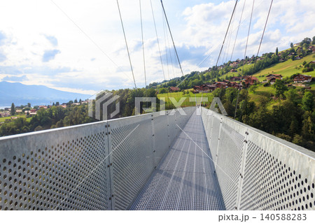 Suspension pedestrian panorama bridge over the Gummi gorge in Sigriswil, Switzerland Suspension pedestrian panorama bridge over the Gummi gorge in Sigriswil, Switzerland 140588283