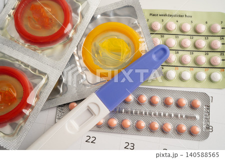 Pregnancy test and birth control pills on calendar, contraception health and medicine. Pregnancy test and birth control pills on calendar, contraception health and medicine. 140588565