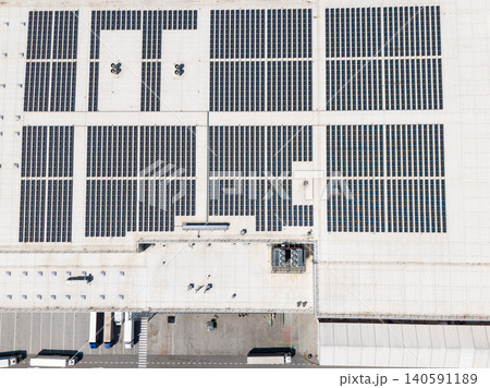 Aerial view of a modern logistics center with solar panels on the roof Aerial view of a modern logistics center with solar panels on the roof 140591189