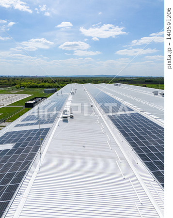 Aerial view of a modern logistics center with solar panels on the roof Aerial view of a modern logistics center with solar panels on the roof 140591206