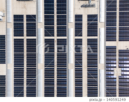 Aerial view of a modern logistics center with solar panels and energy storages on the roof Aerial view of a modern logistics center with solar panels and energy storages on the roof 140591249