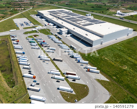 Aerial view of a modern logistics center with solar panels on the roof 140591279