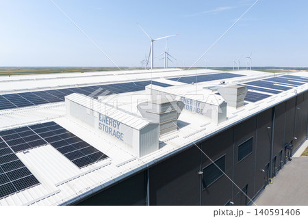Aerial view of a modern logistics center with solar panels and energy storages on the roof Aerial view of a modern logistics center with solar panels and energy storages on the roof 140591406