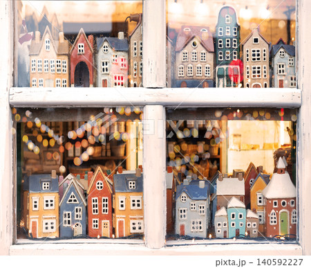 Small houses figurines in a window 140592227