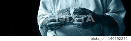 Man's hans holding fresh bread Man's hans holding fresh bread 140592252