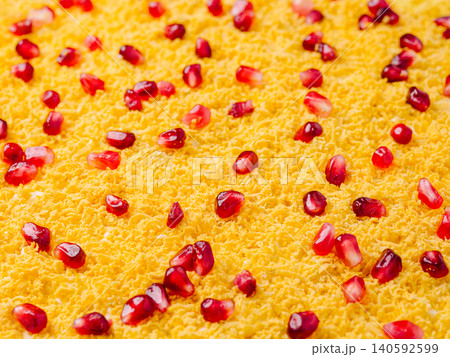 Grated egg yolk with vibrant pomegranate seeds topping Grated egg yolk with vibrant pomegranate seeds topping 140592599