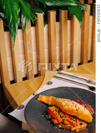 Grilled salmon fillet with roasted vegetables dining Grilled salmon fillet with roasted vegetables dining 140592615
