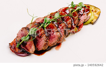 Grilled beef filet slices with roasted vegetables and sauce 140592642