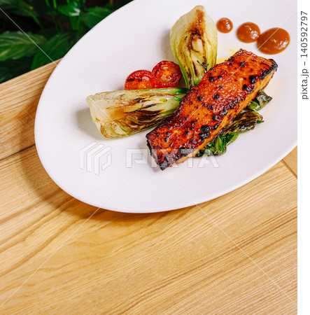 Glazed grilled salmon steak serving with bok choy and tomatoes 140592797
