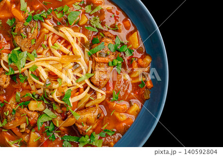 Lagman soup with beef, noodles, and vegetables in bowl Lagman soup with beef, noodles, and vegetables in bowl 140592804