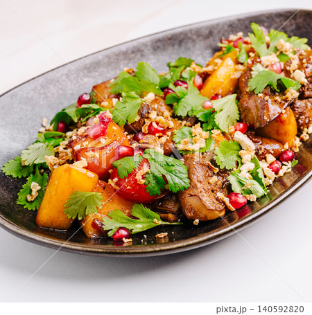Gourmet chicken liver salad with pomegranate and cilantro 140592820