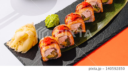 Salmon uramaki sushi rolls on slate board Salmon uramaki sushi rolls on slate board 140592850